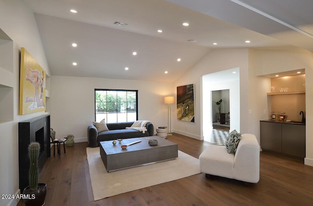 living room with high vaulted ceiling, sink, and dark hardwood / wood-style flooring