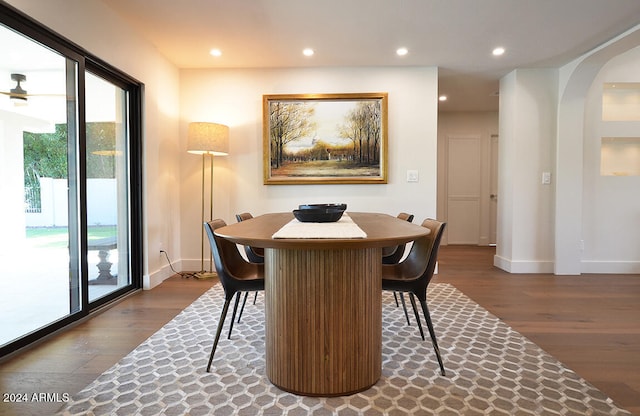 dining area with wood-type flooring, a healthy amount of sunlight, and ceiling fan