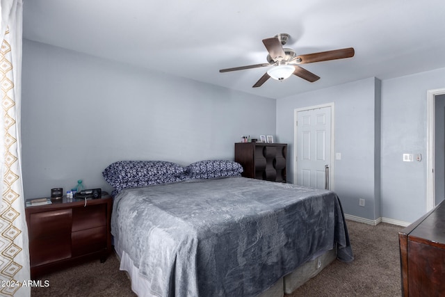 bedroom featuring dark carpet and ceiling fan