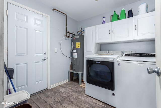 laundry room with washing machine and dryer, cabinets, water heater, and hardwood / wood-style floors