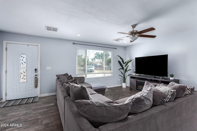 living room featuring ceiling fan and dark hardwood / wood-style flooring