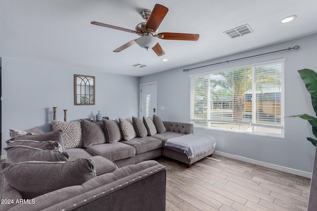 living room featuring ceiling fan and hardwood / wood-style floors