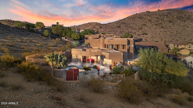 aerial view at dusk featuring a mountain view