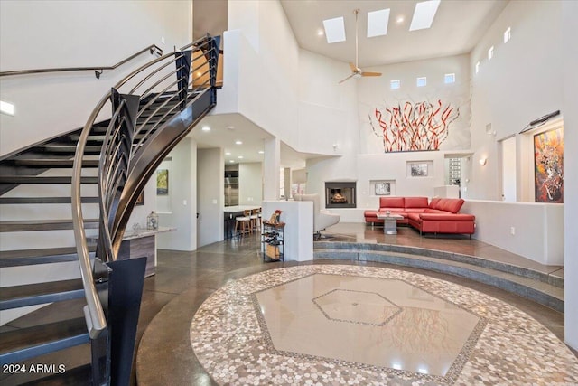 interior space with a skylight and a high ceiling