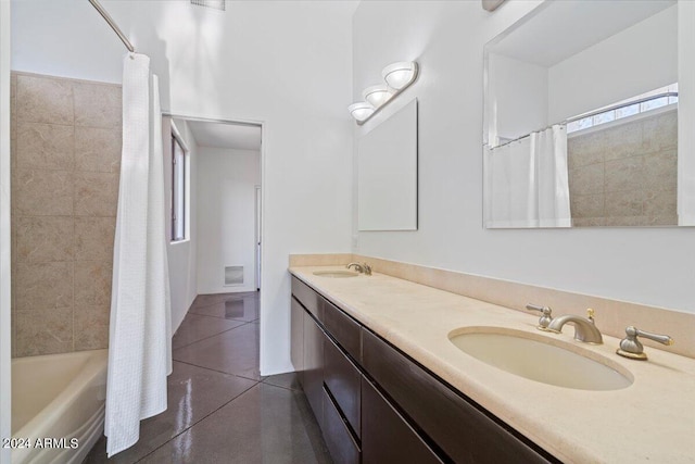 bathroom with vanity, shower / bath combo with shower curtain, and tile patterned flooring