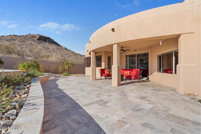 view of patio featuring a mountain view and ceiling fan