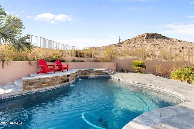 view of pool with a patio and pool water feature