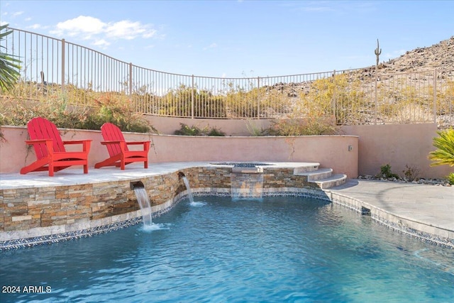 view of swimming pool featuring a patio, an in ground hot tub, and pool water feature