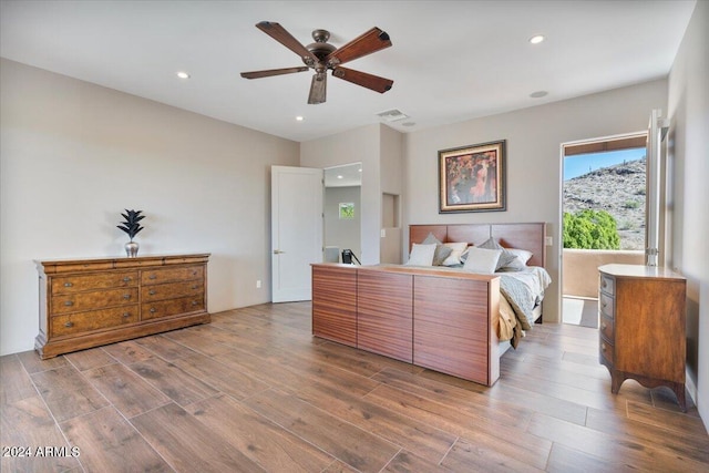 bedroom with hardwood / wood-style flooring and ceiling fan