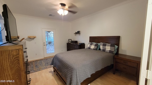 bedroom with access to exterior, visible vents, light wood-type flooring, and ornamental molding