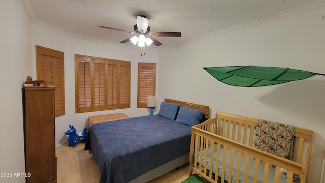 bedroom featuring crown molding, wood finished floors, ceiling fan, and baseboards