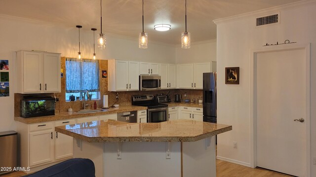 kitchen with white cabinetry, backsplash, visible vents, appliances with stainless steel finishes, and a sink