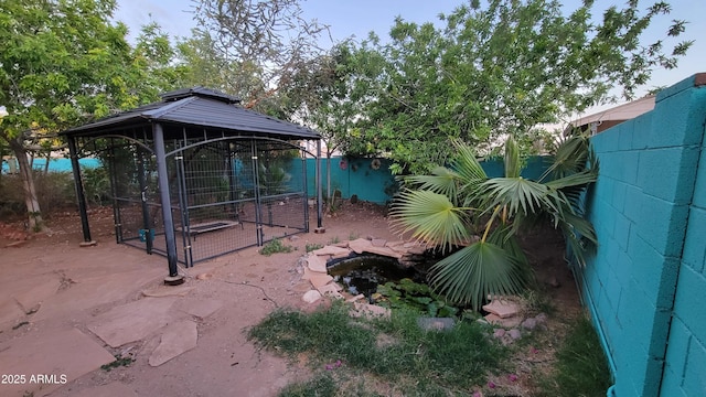 view of yard featuring a gazebo and fence