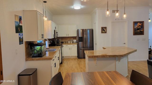 kitchen with tile counters, light wood finished floors, a breakfast bar area, and stainless steel appliances