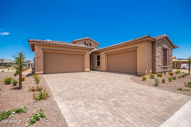 mediterranean / spanish-style home featuring a garage