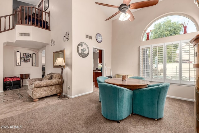 dining space with carpet, ceiling fan, and visible vents