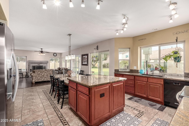 kitchen featuring black dishwasher, a sink, stainless steel fridge with ice dispenser, and plenty of natural light