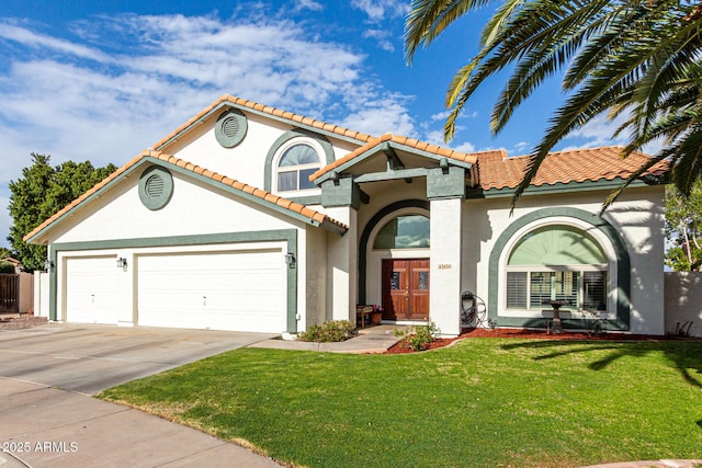 mediterranean / spanish house with a front yard, a tile roof, concrete driveway, and stucco siding