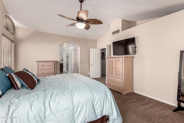 bedroom featuring visible vents, baseboards, arched walkways, lofted ceiling, and dark carpet
