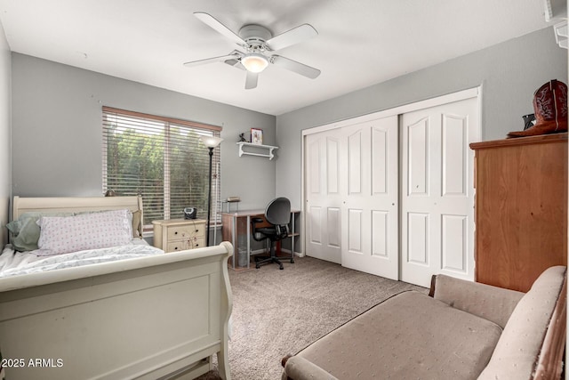 bedroom with a ceiling fan, light carpet, and a closet
