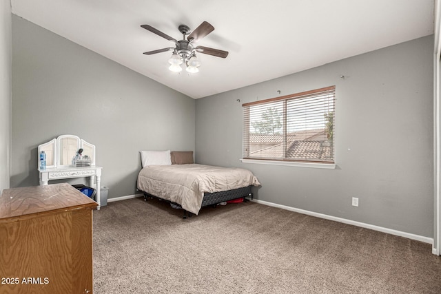 carpeted bedroom with baseboards, vaulted ceiling, and a ceiling fan