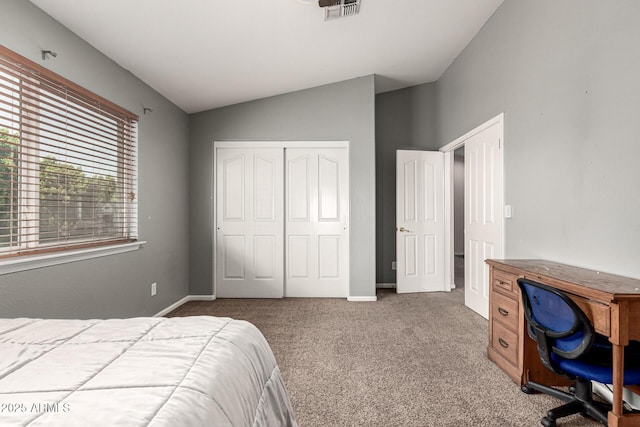 bedroom with vaulted ceiling, baseboards, carpet floors, visible vents, and a closet