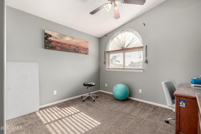 unfurnished office with baseboards, vaulted ceiling, carpet flooring, and a ceiling fan
