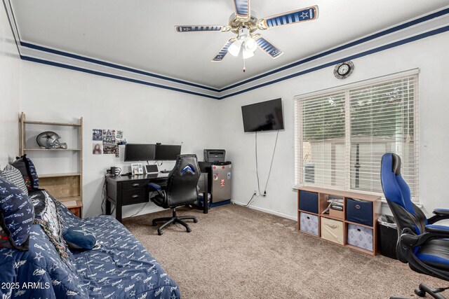 carpeted home office featuring baseboards and ceiling fan