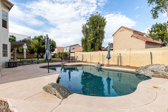 view of pool with a fenced backyard, a patio, and a fenced in pool