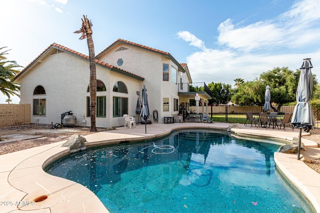 view of swimming pool with a patio, fence, and a fenced in pool