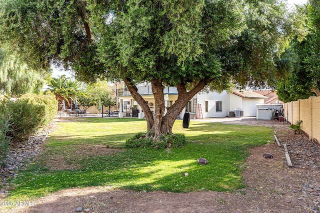 view of yard featuring a fenced backyard, central AC, and a patio area