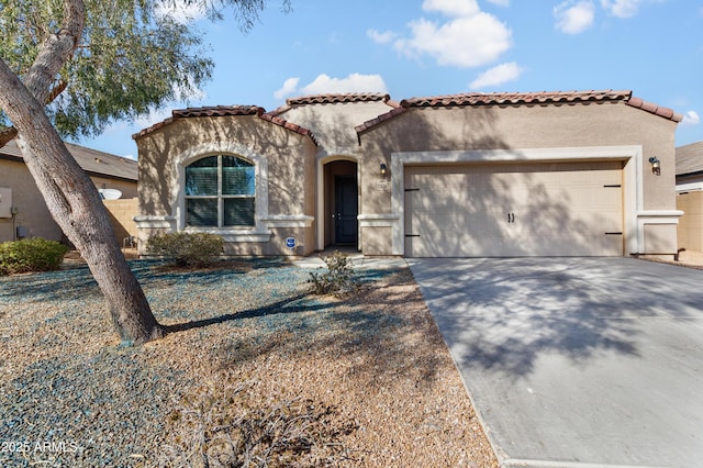 mediterranean / spanish house featuring driveway, a tile roof, a garage, and stucco siding