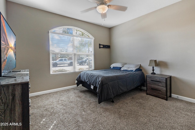 bedroom with ceiling fan, carpet flooring, and baseboards