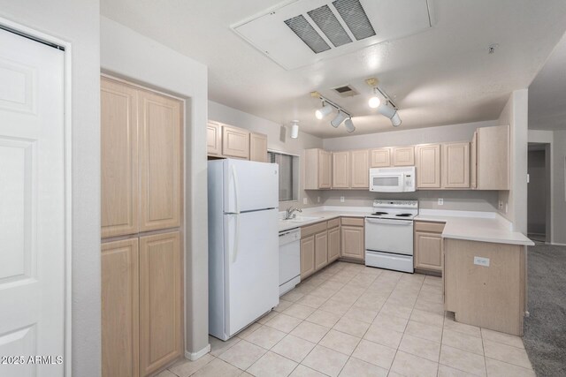 15380 N 100th St Unit 1106, Scottsdale, AZ 85260 - kitchen featuring white appliances, light brown cabinets, a sink, and light countertops