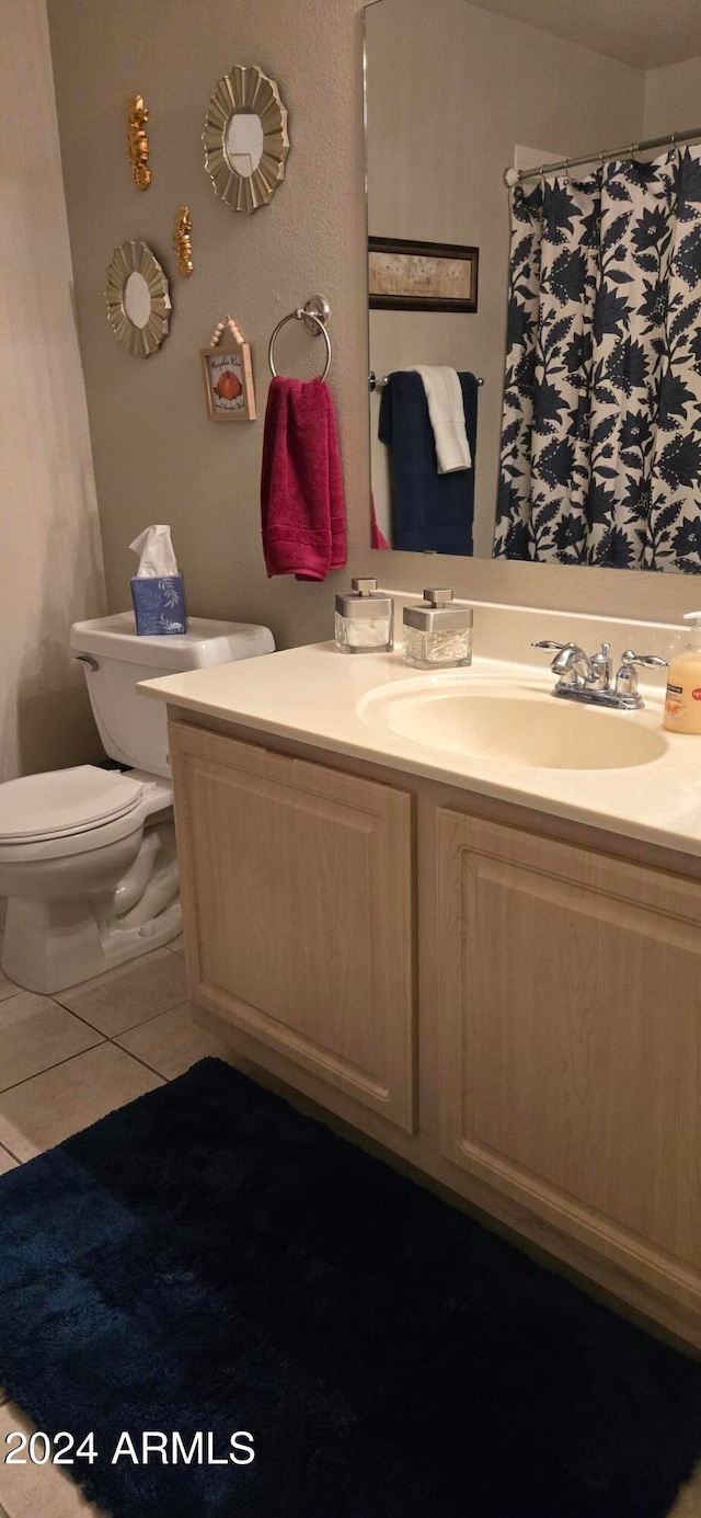 bathroom featuring toilet, vanity, and tile patterned floors