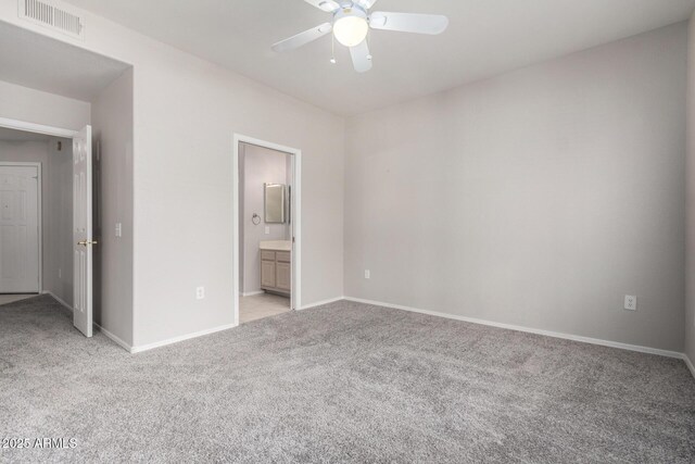 15380 N 100th St Unit 1106, Scottsdale, AZ 85260 - unfurnished bedroom with light colored carpet, baseboards, ensuite bathroom, and ceiling fan