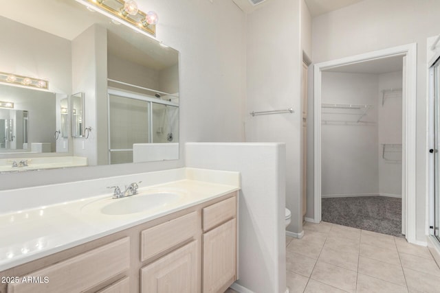 15380 N 100th St Unit 1106, Scottsdale, AZ 85260 - full bathroom featuring a stall shower, toilet, vanity, and a spacious closet