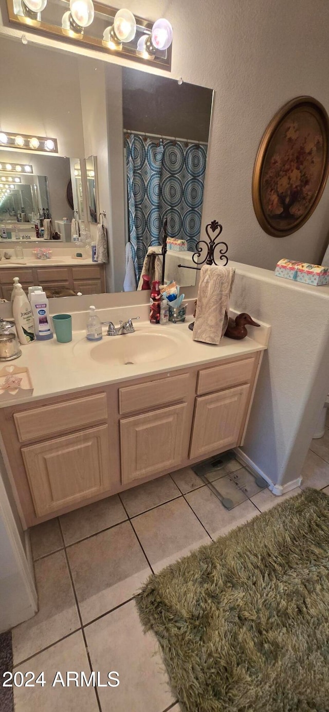 bathroom with tile patterned flooring and vanity