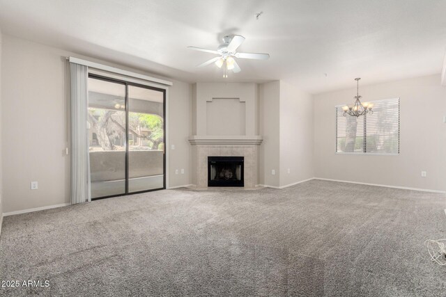 15380 N 100th St Unit 1106, Scottsdale, AZ 85260 - unfurnished living room with a chandelier, a ceiling fan, a fireplace, and carpet