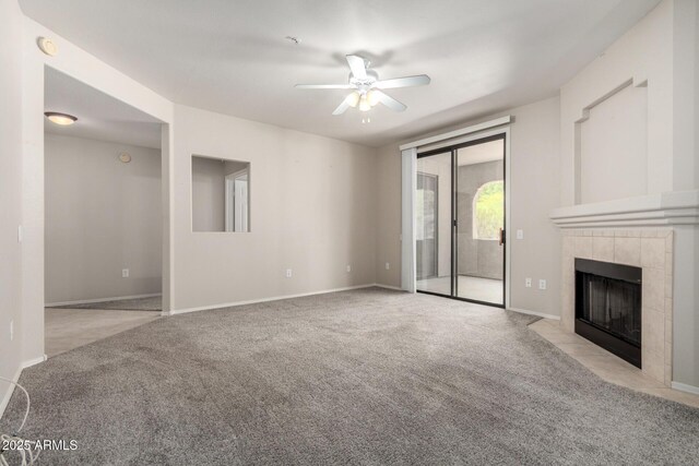 15380 N 100th St Unit 1106, Scottsdale, AZ 85260 - unfurnished living room with carpet flooring, ceiling fan, a tile fireplace, and baseboards
