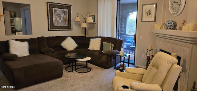 carpeted living room featuring a tile fireplace