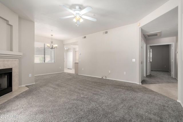 15380 N 100th St Unit 1106, Scottsdale, AZ 85260 - unfurnished living room with carpet floors, a ceiling fan, a tiled fireplace, a chandelier, and baseboards