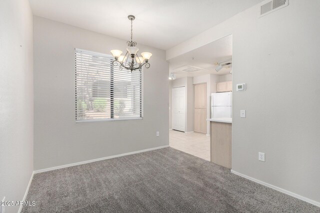 15380 N 100th St Unit 1106, Scottsdale, AZ 85260 - spare room with light carpet, a chandelier, and baseboards