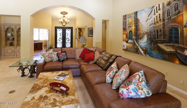 living room with tile floors and an inviting chandelier