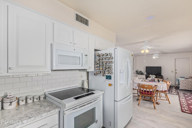 kitchen with light wood-type flooring, white appliances, ceiling fan, and white cabinets