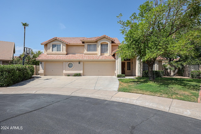 mediterranean / spanish-style house with a front yard and a garage