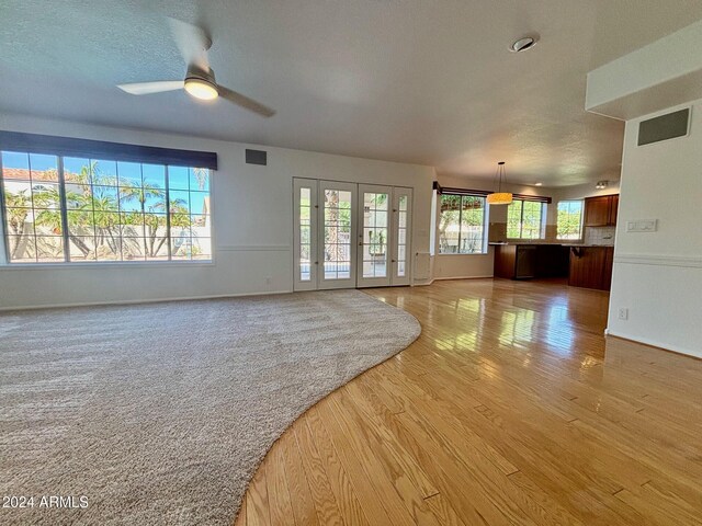 kitchen with sink, a kitchen island, light hardwood / wood-style flooring, appliances with stainless steel finishes, and light stone countertops