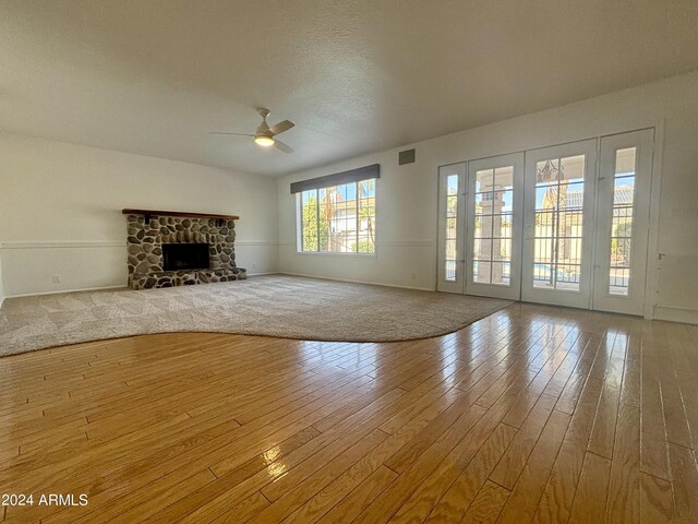 kitchen with stainless steel appliances, light stone countertops, tasteful backsplash, and light wood-type flooring