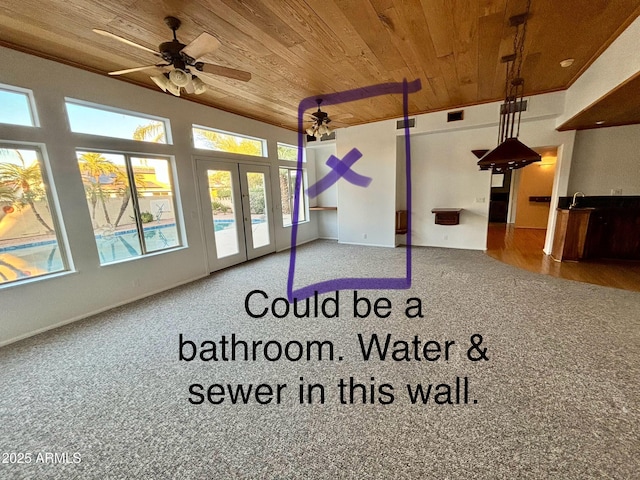 interior space with ceiling fan and wooden ceiling