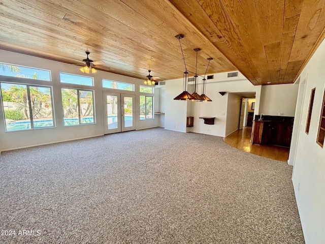 unfurnished living room featuring wood ceiling, ceiling fan, and carpet floors